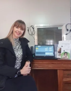 Audiologist consulting with a patient in a bright, modern clinic examining hearing health needs